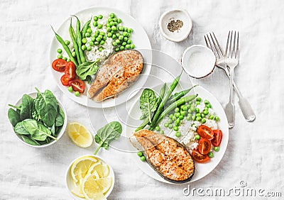 Healthy balanced mediterranean diet lunch - baked salmon, rice, green peas and green beans on a light background, top view. Stock Photo