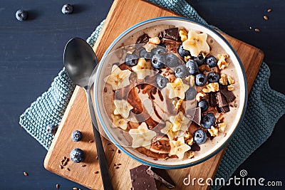 Healthy banana smoothie bowl with blueberry chocolate walnuts Stock Photo