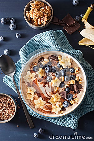 Healthy banana smoothie bowl with blueberry chocolate walnuts Stock Photo