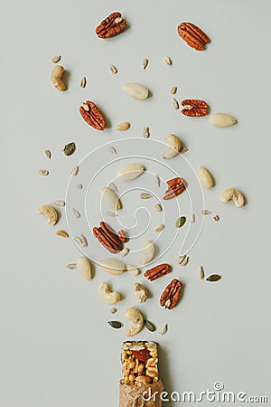 Healthy bar with nuts and seeds on the gray background, top view Stock Photo