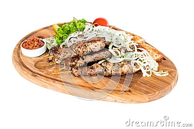 Healthy barbecued lean cubed pork kebabs served with a corn tortilla and fresh lettuce and tomato salad Stock Photo