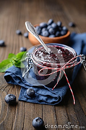 Healthy blueberry jam in a glass jar served with fresh berries Stock Photo