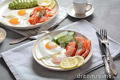 Healthy breakfast concept, fried eggs, avocado and smoked salmon Stock Photo