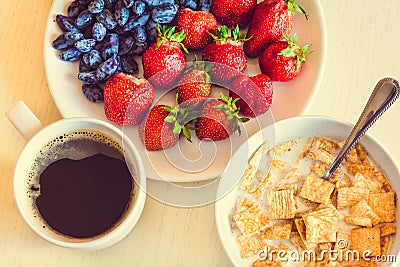 Healthy breakfast. Corn flakes with ripe red strawberry, blue ho Stock Photo