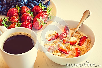 Healthy breakfast. Corn flakes with ripe red strawberry, blue ho Stock Photo
