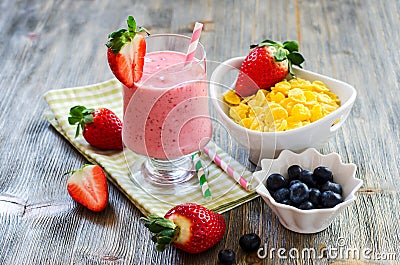 Healthy breakfast with cornflakes, strawberry smoothie and blueberries Stock Photo