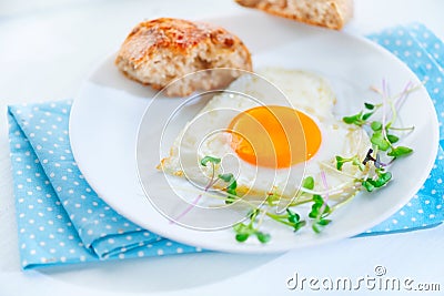 Healthy breakfast. Fried heart shaped egg Stock Photo
