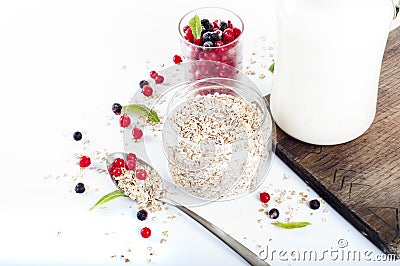 Healthy breakfast: oat flakes in bowls, fresh berries and milk Stock Photo