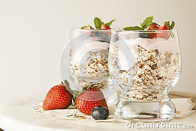 Healthy breakfast, oat meal with fruits: bluebery, strawbery and min, parfait in a glass on a rustic background. Healthy food. Stock Photo