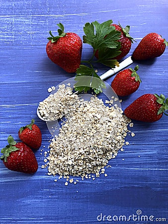 Healthy breakfast oatmeal, bananas and strawberries on wooden background. Stock Photo