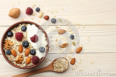 healthy breakfast. oatmeal, blueberries, raspberries and nuts on white wooden table. Top view with copy space Stock Photo