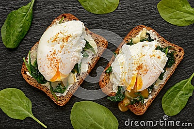 Healthy breakfast - sandwich with creme cheese, spinach and poached egg. Stock Photo