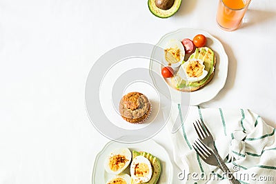 Healthy breakfast: toasts with avocado slices, tomato, paprika and eggs Stock Photo