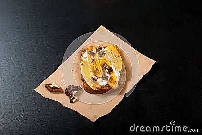 Tasty sweet sandwiches with bananas, nuts and chocolate, on bla Stock Photo