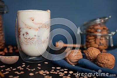 Healthy Breakfast yogurt with oatmeal and walnuts, almonds and peanuts with honey Stock Photo
