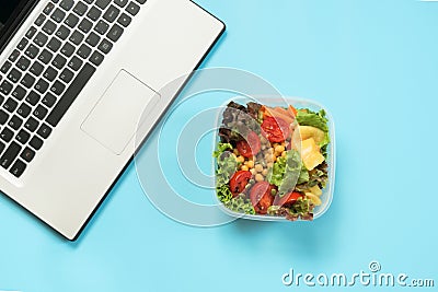 Healthy business lunch in the office, salad for snack on blue table. Top view with copy space. Concept proper nutrition. Take away Stock Photo