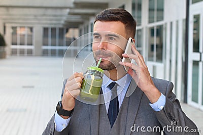 Healthy businessman drinking juice while working Stock Photo