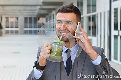 Healthy businessman drinking juice while working Stock Photo