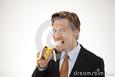 Healthy businessman eating banana Stock Photo