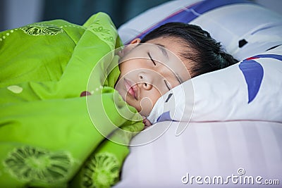 Healthy child. Little asian boy sleeping peacefully on bed. Stock Photo