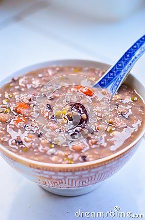 Healthy Chinese Grain Porridge in a Bowl with Jujube & Goji Berry on Top Stock Photo