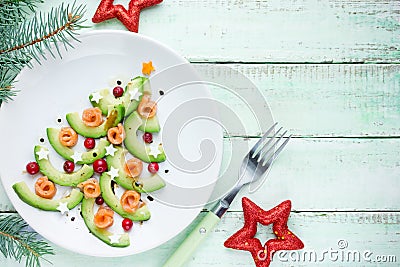 Healthy Christmas appetizer snack - avocado salmon cranberry Christmas tree Stock Photo