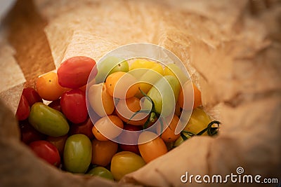 Healthy colorful cherry tomatoes in paper bag Stock Photo