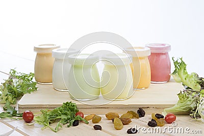 Healthy coloured yogurts with fruits and nuts Stock Photo