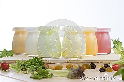 Healthy coloured yogurts with fruits and nuts Stock Photo