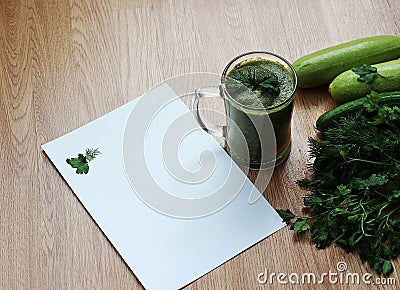 Blended green smoothie with ingredients on wooden table. Stock Photo