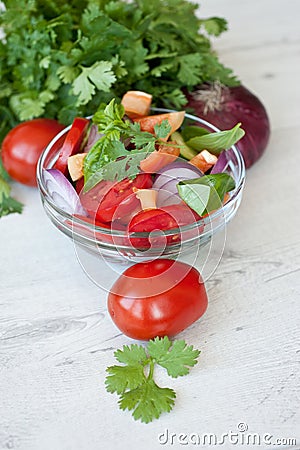 Healthy cooking of salad with fresh delicious ingredients making on cutting board. Stock Photo