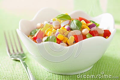 Healthy corn salad with tomato onion white bean basil Stock Photo
