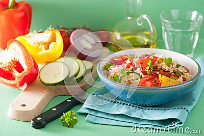 Healthy couscous salad with tomato pepper zucchini onion Stock Photo