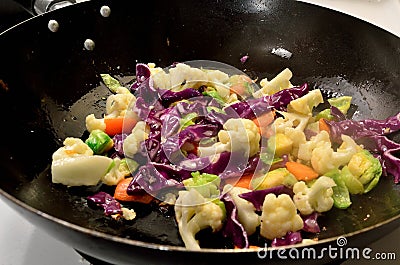 Stir Fry Vegetables in Wok â€“ ingredients Brussels Sprouts Carrots Cauliflower Red Cabbage Stock Photo