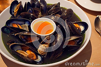 Healthy delicious seafood soup with mussels with cream sauce and herbs Stock Photo