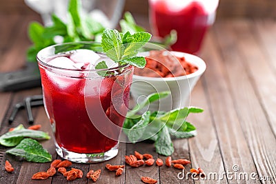 Healthy detox drink with goji berries infused in water with ice, cold refreshing beverage close-up Stock Photo