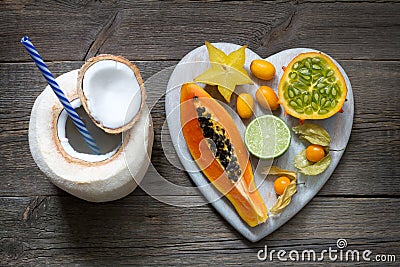 Healthy diet concept with coconut milk and tropical fruit heart Stock Photo