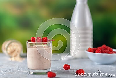 Healthy dietary food. Oatmeal milkshake with bananas and raspberries. Stock Photo