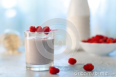 Healthy dietary food. Oatmeal milkshake with bananas and raspberries. Stock Photo