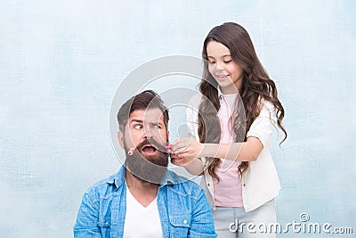 With healthy dose of openness any dad can excel at raising girl. Child making hairstyle styling father beard. Being Stock Photo