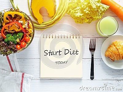 Healthy eating, dieting, slimming and weight loss goals concept. target of diet plan on paper with salad bowl, fresh vegetable Stock Photo