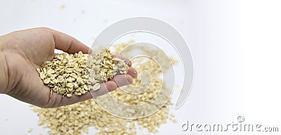 close up of woman hand holding handfull oatmeal flakes over white Stock Photo