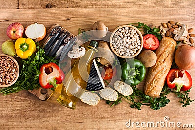 Healthy eating. Mediterranean diet. Fruit,vegetables, grain, nuts olive oil and fish on wood Stock Photo