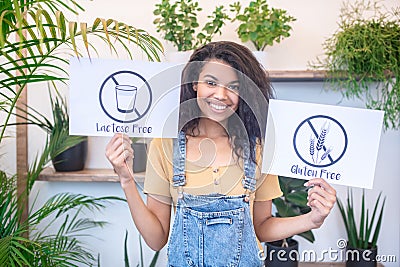 Smiling woman with lactose free gluten free posters Stock Photo