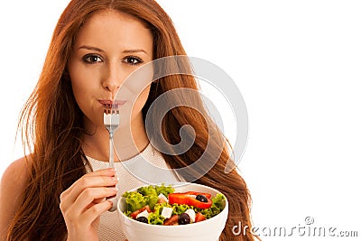 Healthy eating - woman eats a bowl of greek salad isolated over Stock Photo