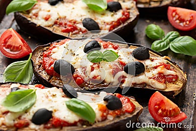 Healthy Eggplant or Aubergine pizza with tomato sauce, mozzarella cheese, basil and olives Stock Photo