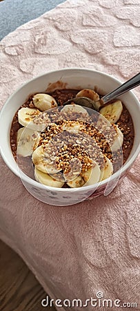 Healthy and fast breakfast oatmeal with cocoa and banana Stock Photo