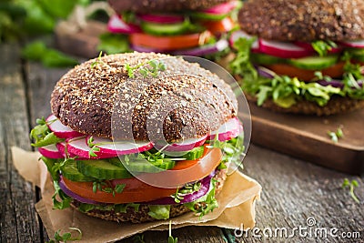 Healthy fast food. Vegan rye burger with fresh vegetables Stock Photo