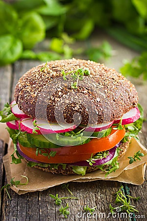 Healthy fast food. Vegan rye burger with fresh vegetables Stock Photo