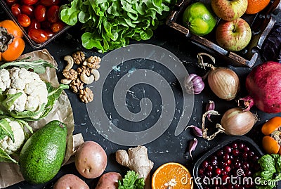 Healthy food background. Assortment of fresh vegetables and fruits on a dark background. Free space for text, top view. Stock Photo